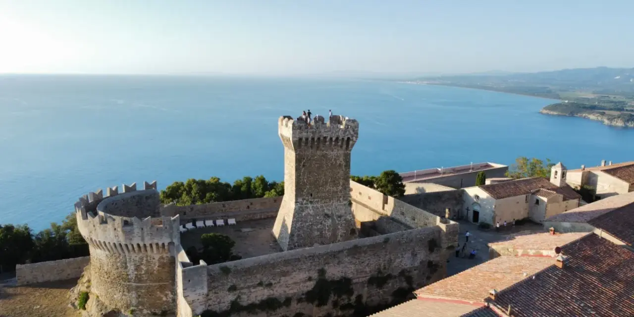 Rocca di Populonia, uno dei luoghi imperdibili da vedere a Piombino, domina il mare blu.