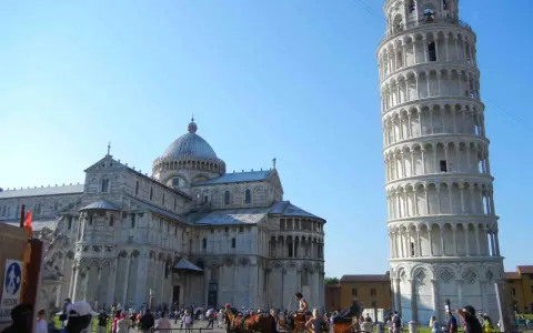 Piazza dei Miracoli a Pisa: la Torre Pendente, il Duomo e una carrozza trainata da cavalli. Ideale per scoprire cosa fare a Pisa.